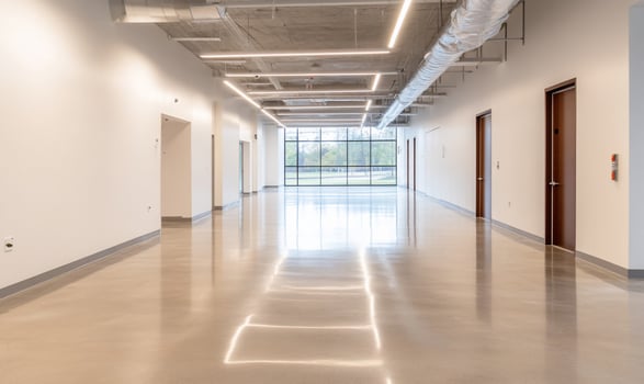 A modern, empty hallway with polished floors and large windows. photo