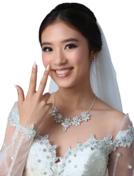 A woman in a wedding dress making the peace sign photo