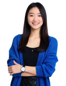 A young woman in a blue cardigan and black top photo