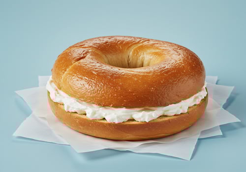 Golden Bagel Topped with Creamy Sweet Spread photo