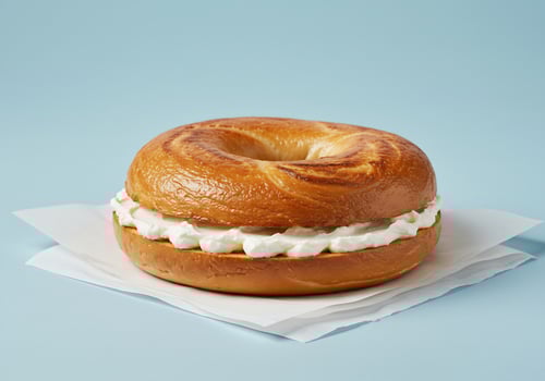 Cream cheese bagel on pale blue photo