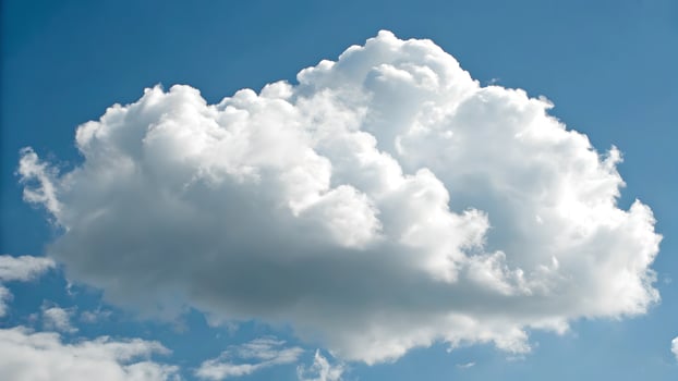 Fluffy white cloud formation in vibrant blue sky for nature enthusiasts and photographers seeking serene outdoor backgrounds photo