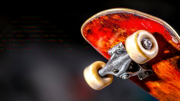 Close Up Red Brown Fingerboard with Off White Wheels Dark Background photo