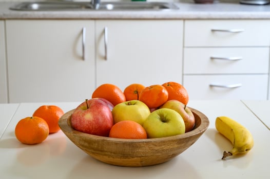 Cooking a healthy food or a breakfast. A bowl of fruits on the table. photo