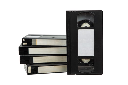 A stack of vintage VHS tapes with blank labels, isolated on a white background. photo