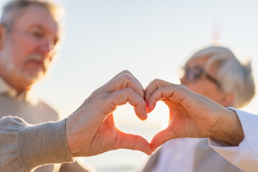 Love heart shape peace. Senior older couple making heart shape with their hands. Adult mature old husband wife showing heart sign. Happy pensioner family. I love you happy valentines day photo