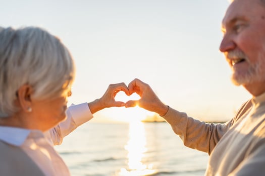 Love heart shape peace. Senior older couple making heart shape with their hands. Adult mature old husband wife showing heart sign. Happy pensioner family. I love you happy valentines day photo