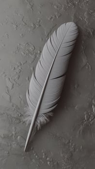 A white feather laying on a table photo
