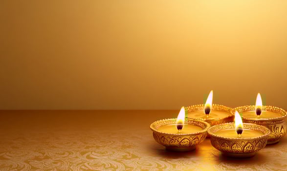 Four lit oil lamps on a golden background, symbolizing celebration and light. photo