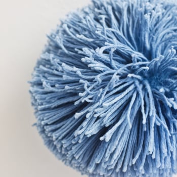 Close up blue pom pom with white background photo