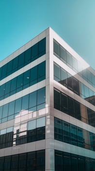 A modern office building with a blue sky in the background photo