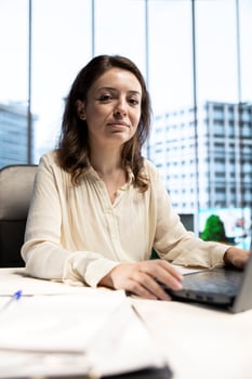 Portrait of successful female director working in a corporate office, managing daily business operations, optimizing workflow and ensuring that the company meets its performance targets. photo