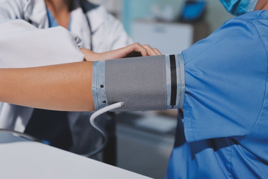 A doctor checking the blood pressure of a patient photo
