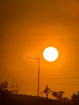 Silhouette of TV Antenna with Glowing Sunrise and Nostalgic Vibe photo