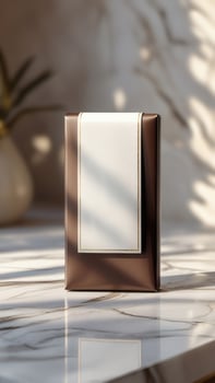 Elegant Package Design. Brown packaging featuring a white label with gold trim, sitting on a glossy marble surface. A product presentation. photo
