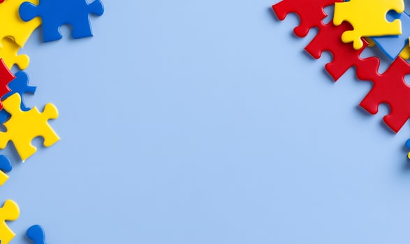 Colorful puzzle pieces on blue background. Teamwork concept photo