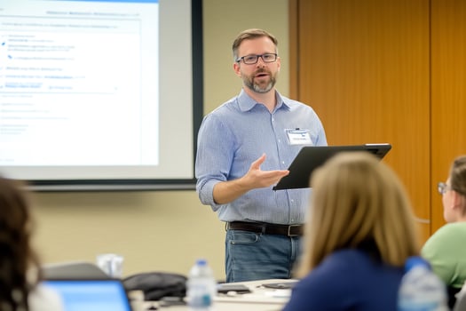 Professor lectures students in classroom photo