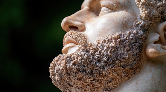 Close up of a marble statue of a man with a beard photo