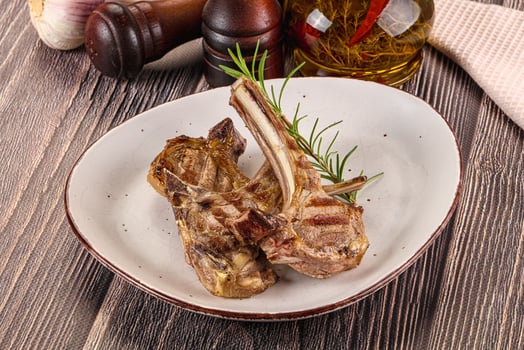 A plate of meat and vegetables on a table photo