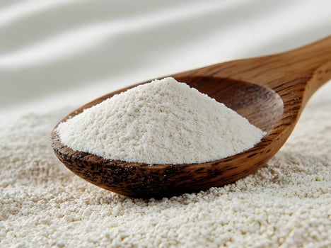 Wooden Spoon Holding A Mound Of White Powder photo