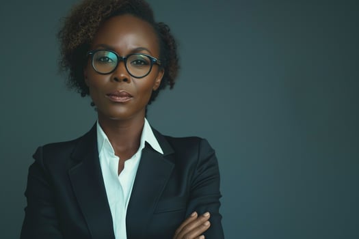 Confident Black woman in a sleek black suit with glasses, exuding professionalism and poise. photo