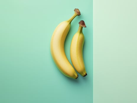 Fresh bananas in minimalistic style against pastel green background photo