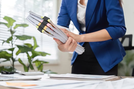 Close-up of accountant organizing tax documents in a professional office photo