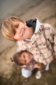 Dressed in plaid shirts, two children , playing and sharing a moment of happiness. photo