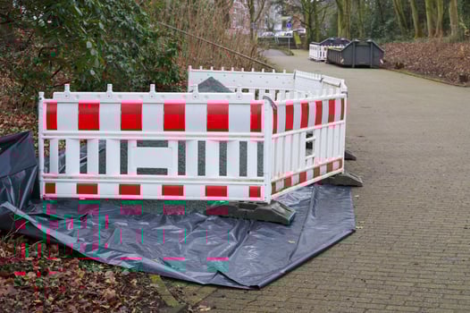 Construction site barrier protecting gravel pile and covered ground photo