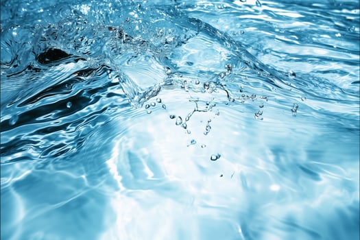 A mesmerizing view of a crystal clear blue wave, showcasing its fluid motion and refreshing essence. photo
