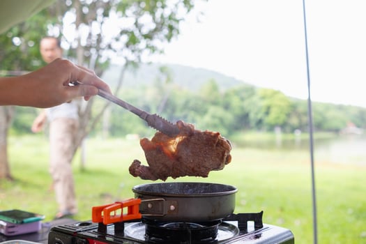 A person cooking food on a stove photo