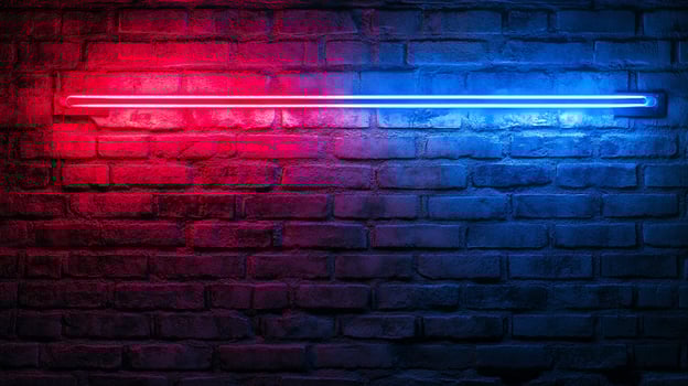 Red and blue neon light casting a vibrant glow on a brick wall. The contrasting colors create a striking visual effect. Modern and edgy. photo
