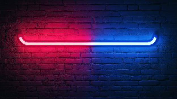 A vibrant neon light bar is affixed to a textured brick wall, split with red on the left and blue on the right, creating a striking contrast. photo