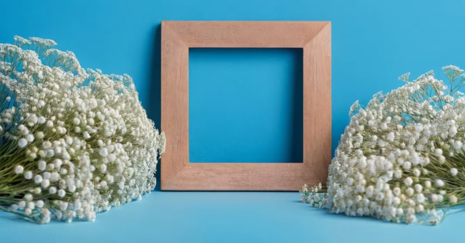 Wooden frame with white flowers on blue background photo
