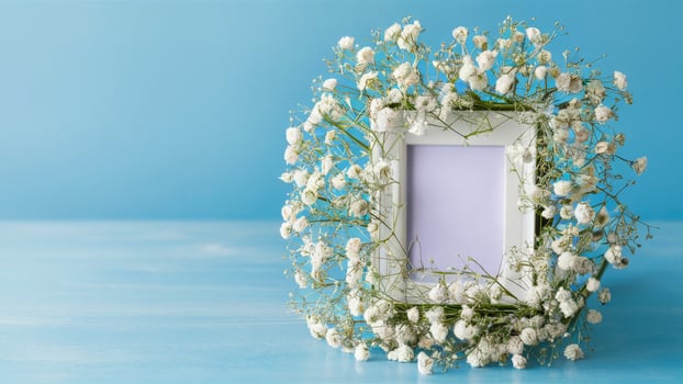 Photo frame with lily of the valley flowers on blue background