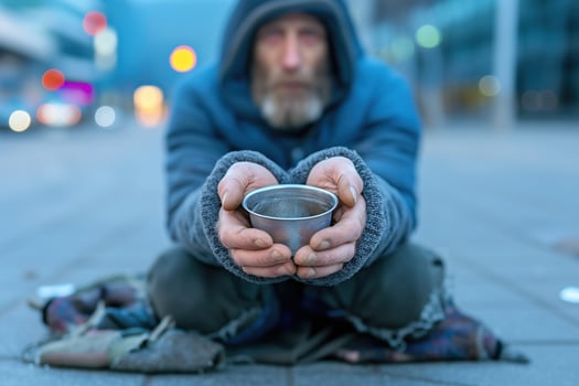 Homeless person sitting in the street and begging for money. photo