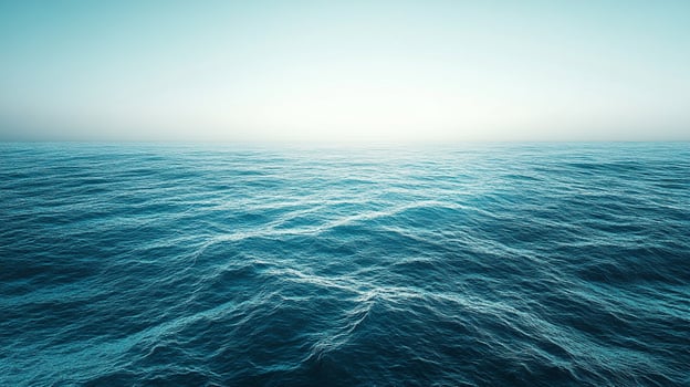 Vast expanse of open ocean reflecting a soft, gradient sky, showcasing the serene beauty and boundless nature of water meeting the horizon. photo