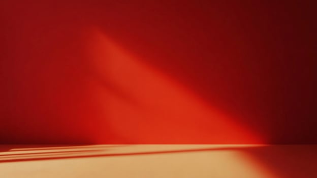 Abstract red wall and floor bathed in sunlight, creating shadows. Minimalist backdrop with warm tones and clean lines for product showcase. photo