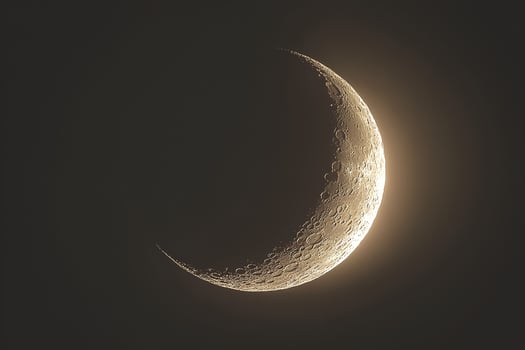 A striking image of a half moon against a dark, starless background, highlighting its illuminated surface and casting a serene glow photo
