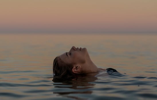 beautiful girl is relaxing in the sea, relaxing and taking care of herself. Profile portrait of a young woman floating in water, High quality photo. photo