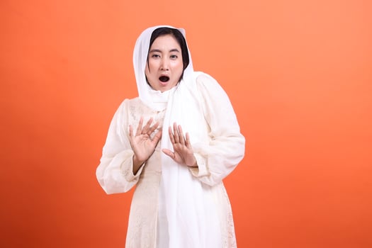 Startled Expression, Woman in hijab conveys shock and caution wi photo