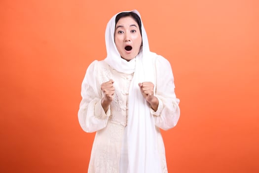 Astonished muslimah, portrait of a woman with a headscarf expres photo