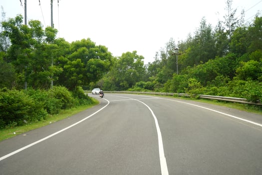 Clean and traffic free highway between green forest at odisha photo