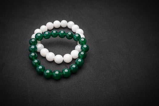 Two Jade bangles or bracelets on a black background photo