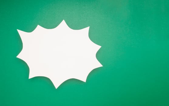 A blank white comic speech bubble on a green background photo