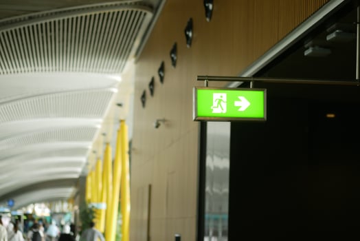 Emergency exit sign in modern indoor airport terminal area photo