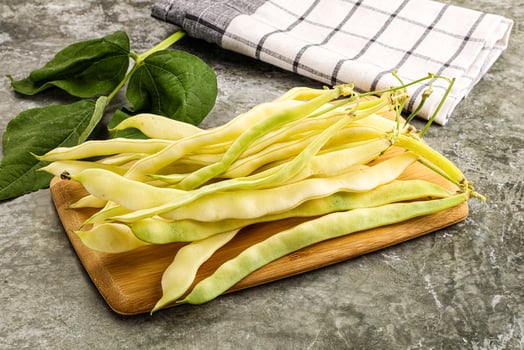 A bunch of beans on a cutting board photo