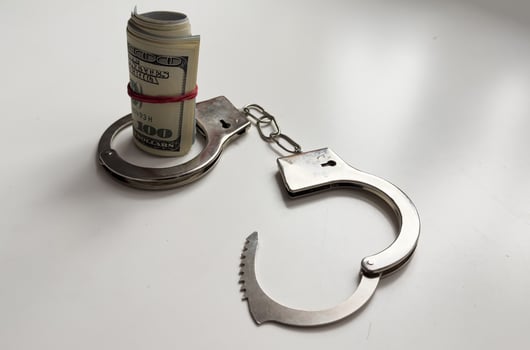Money and handcuffs isolated on white background photo