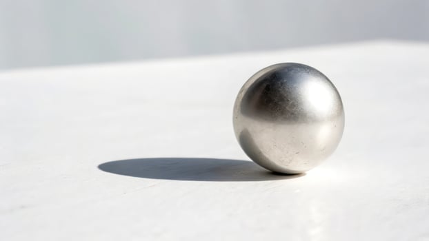 A silver ball sitting on top of a table photo