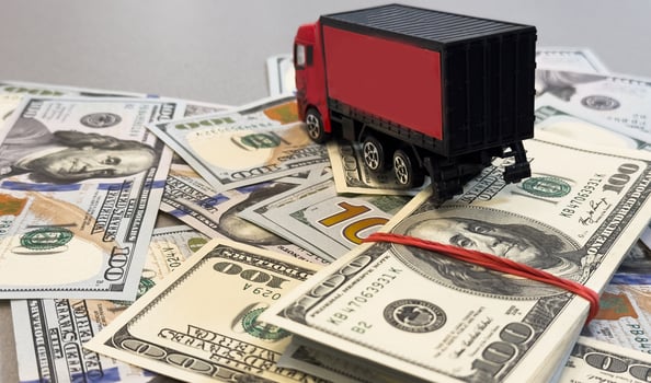 Toy car truck with money isolated on white background photo